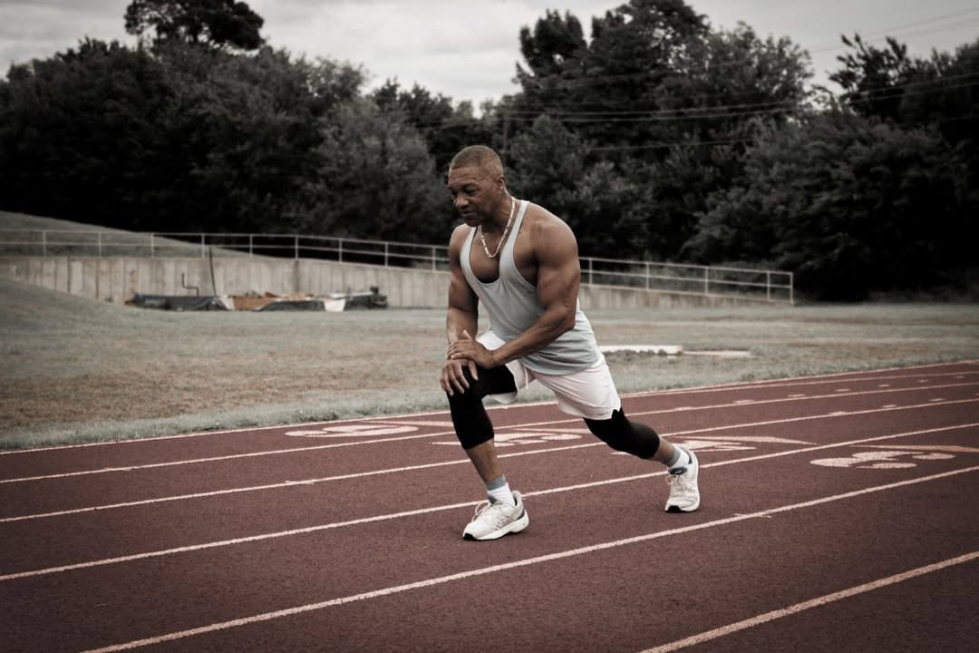 Athlete stretching on a running track