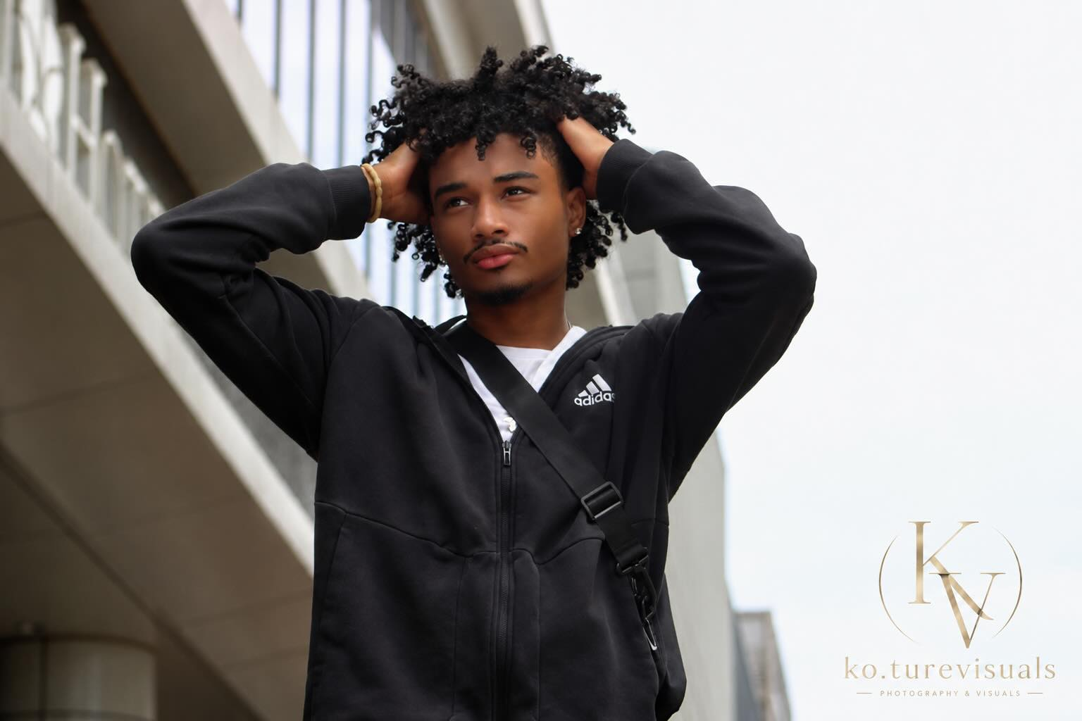 Man posing with his hands in his hair